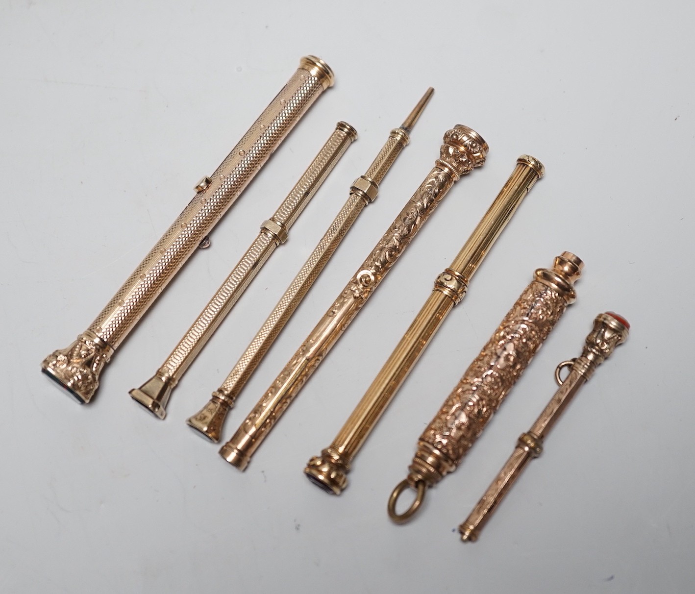 Seven assorted yellow metal overlaid and gem set propelling pencils